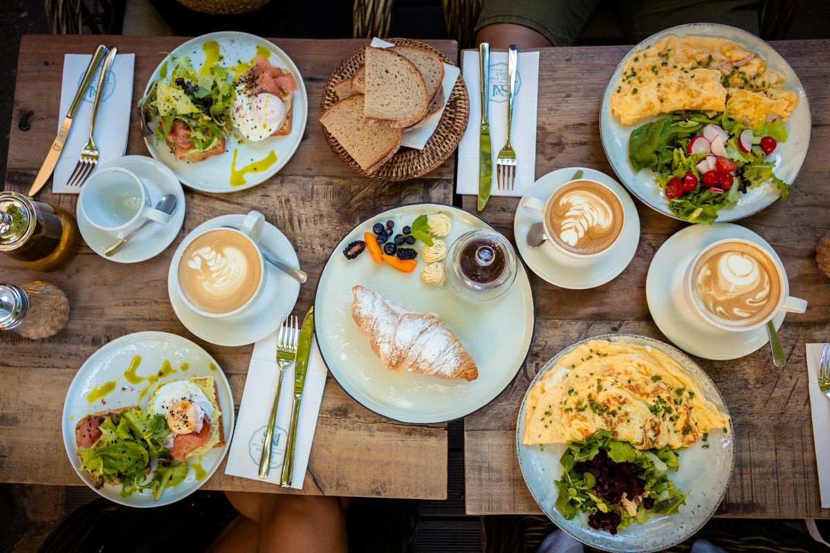 Breakfast spread with eggs, salads, and coffee showing the benefits of protein